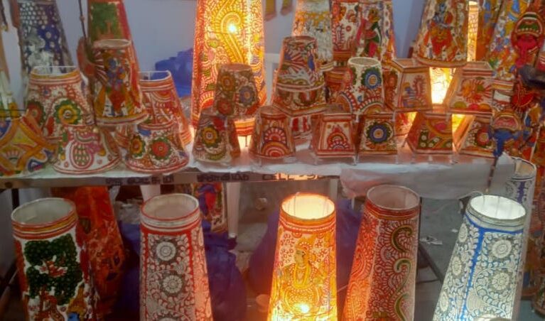 Tw rows of Tholu Bommalata lampshades in various sizes in display.