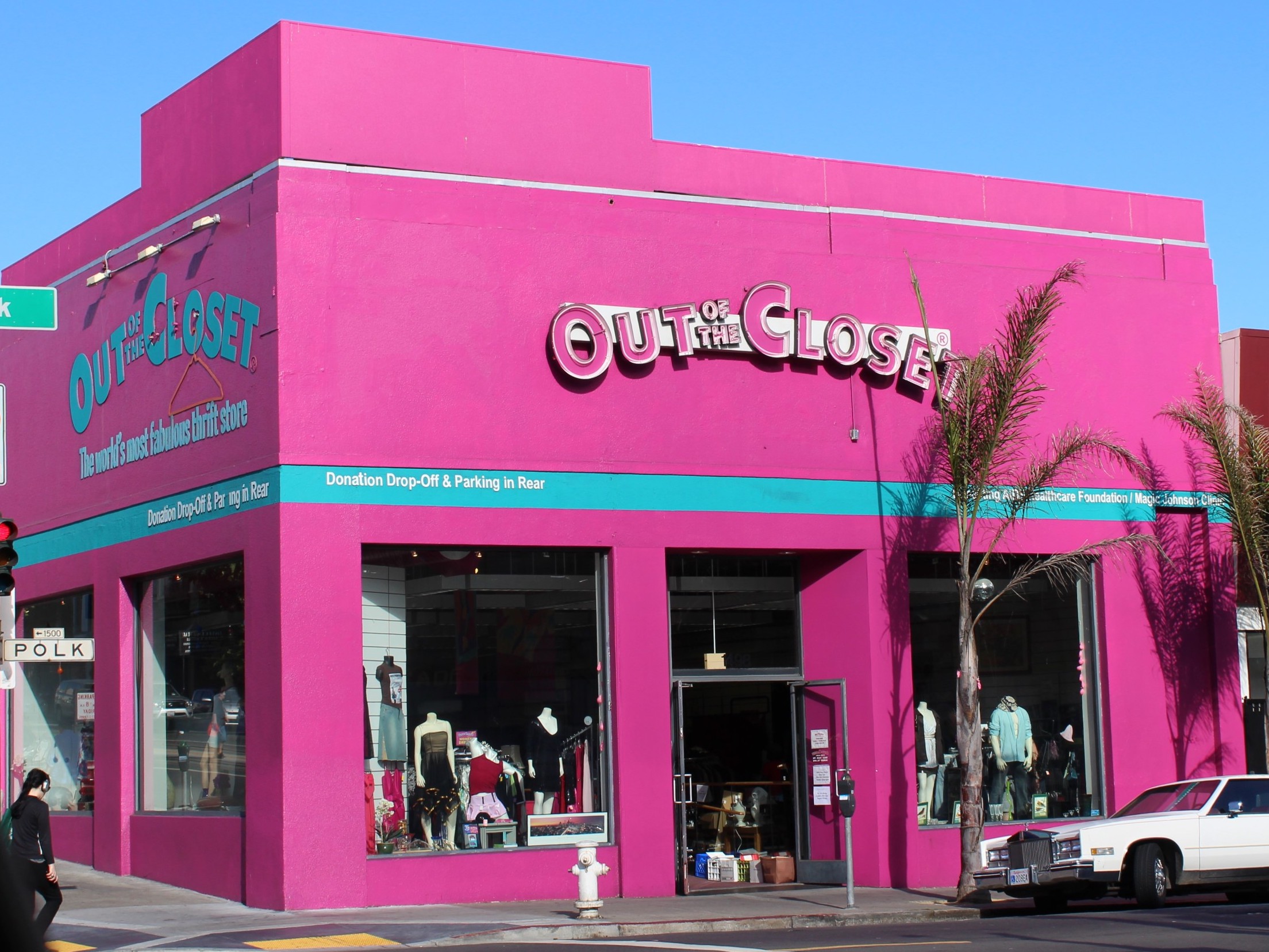 Exterior of a pink shop facade with the sign "Out of the Closet". This is a thrift shop