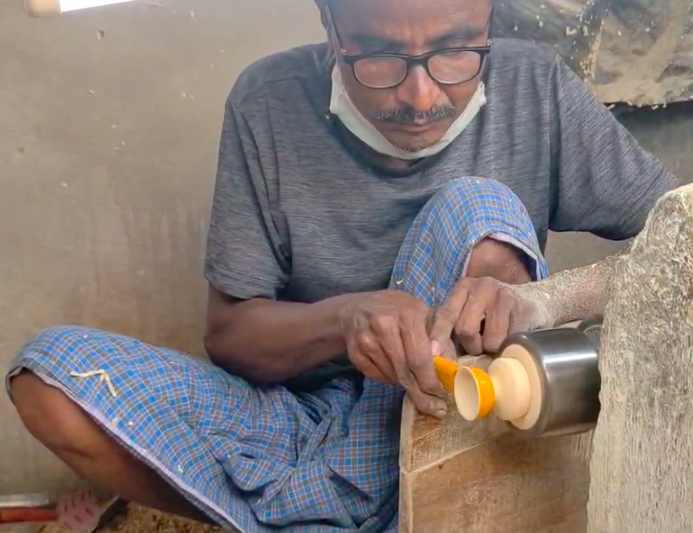Mr Pedapati working to give colour to the Etikoppaka lamp
